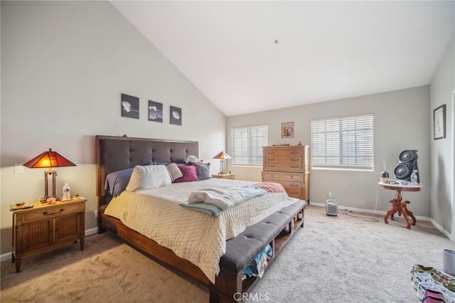 carpeted bedroom with vaulted ceiling and baseboards