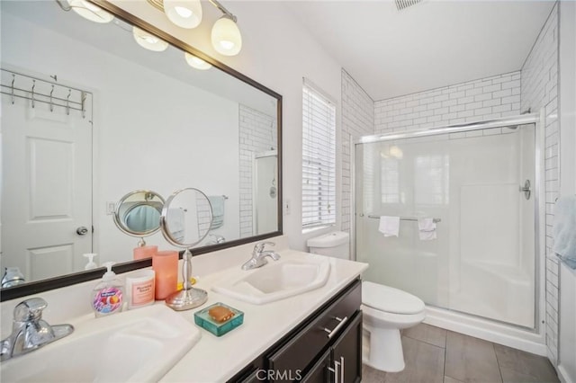 full bath with a shower stall, toilet, and a sink