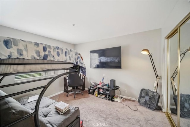 bedroom with carpet flooring and baseboards