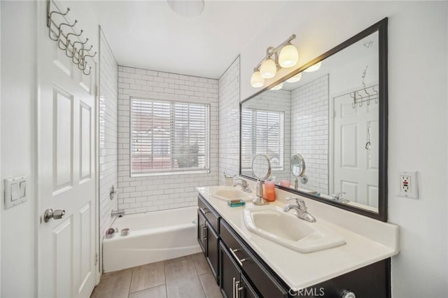 full bath featuring a tub, a sink, and double vanity