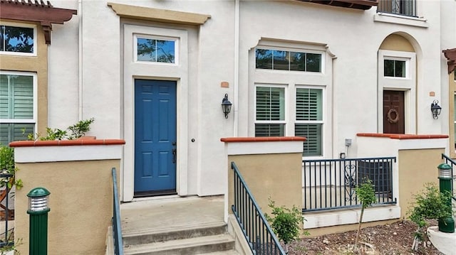 763 W 1st St Unit 80, Claremont, CA 91711 - view of exterior entry featuring stucco siding and fence