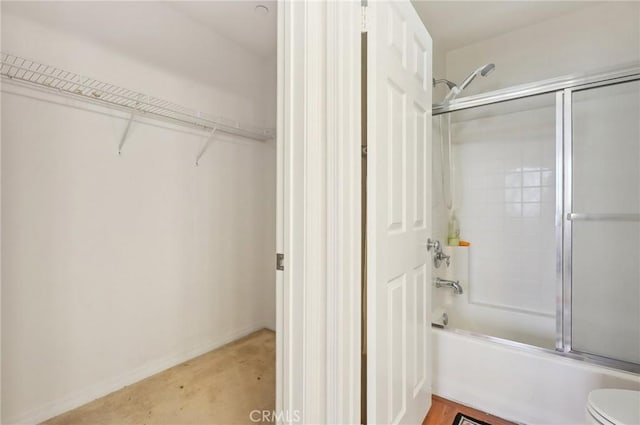 763 W 1st St Unit 80, Claremont, CA 91711 - bathroom with concrete flooring, baseboards, toilet, and enclosed tub / shower combo