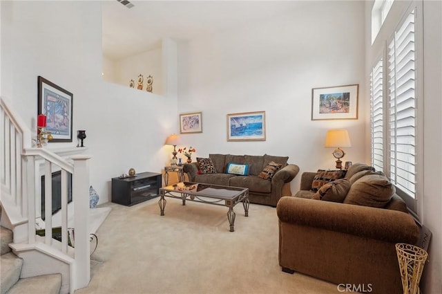 763 W 1st St Unit 80, Claremont, CA 91711 - carpeted living room with visible vents, a towering ceiling, and stairs