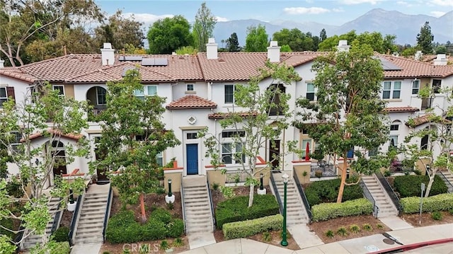 763 W 1st St Unit 80, Claremont, CA 91711 - view of front facade featuring a tiled roof, stairs, and stucco siding