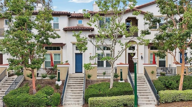 763 W 1st St Unit 80, Claremont, CA 91711 - view of front of property with stucco siding, a tile roof, and stairway