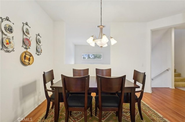 763 W 1st St Unit 80, Claremont, CA 91711 - dining room featuring stairway, an inviting chandelier, and wood finished floors