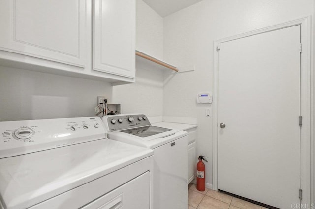 1450 Oakpoint Ave, Chula Vista, CA 91913 - laundry area with washing machine and clothes dryer, cabinet space, and light tile patterned floors