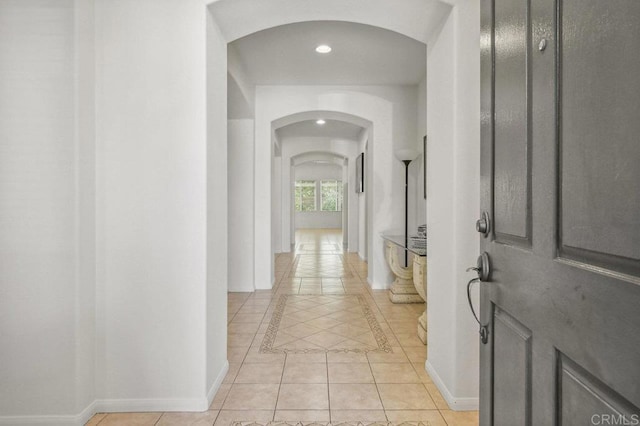 1450 Oakpoint Ave, Chula Vista, CA 91913 - hallway featuring arched walkways, light tile patterned floors, recessed lighting, and inlaid floor details