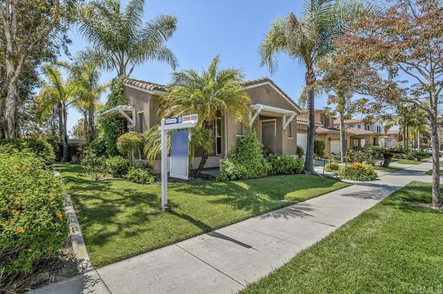1450 Oakpoint Ave, Chula Vista, CA 91913 - view of front of property featuring stucco siding, a front yard, and a tile roof