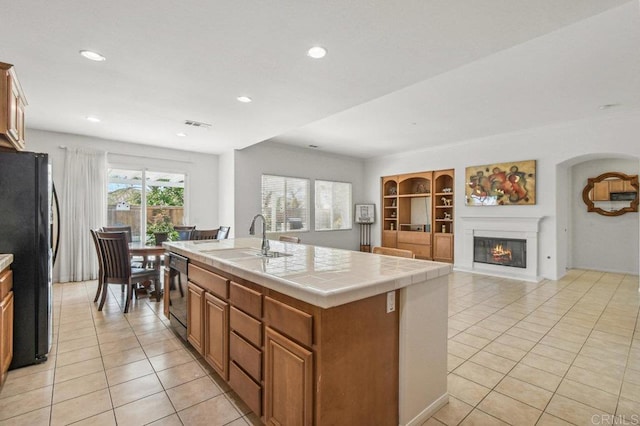 1450 Oakpoint Ave, Chula Vista, CA 91913 - kitchen with black appliances, light tile patterned flooring, tile countertops, built in features, and recessed lighting