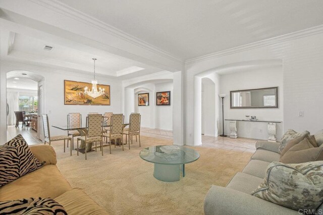 1450 Oakpoint Ave, Chula Vista, CA 91913 - living room featuring arched walkways, a chandelier, ornamental molding, carpet, and a raised ceiling