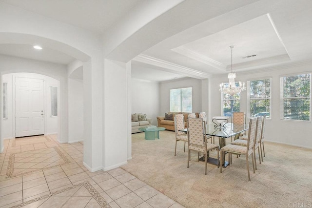 1450 Oakpoint Ave, Chula Vista, CA 91913 - dining space with a chandelier, light tile patterned floors, arched walkways, a raised ceiling, and crown molding