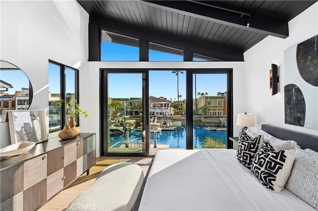 4017 Channel Pl, Newport Beach, CA 92663 - bedroom with light wood finished floors, multiple windows, access to outside, and lofted ceiling with beams