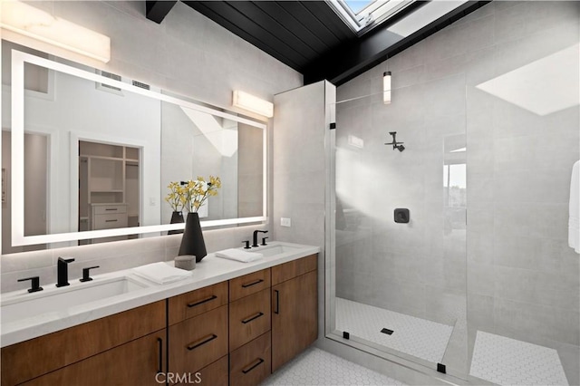 4017 Channel Pl, Newport Beach, CA 92663 - full bathroom featuring a tile shower, a sink, double vanity, and a skylight