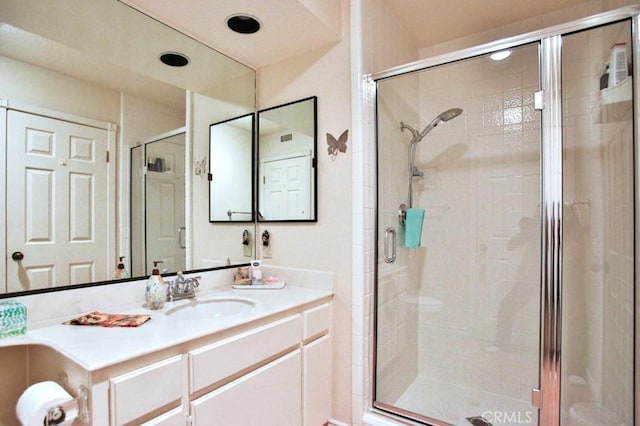 full bathroom featuring a shower stall and vanity