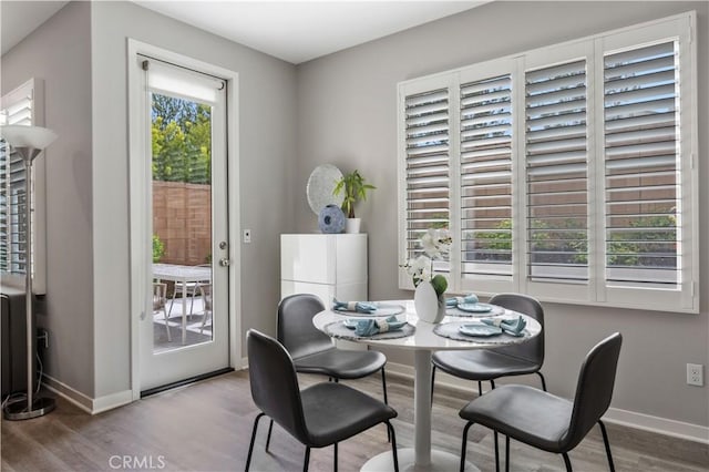 dining area featuring baseboards and wood finished floors