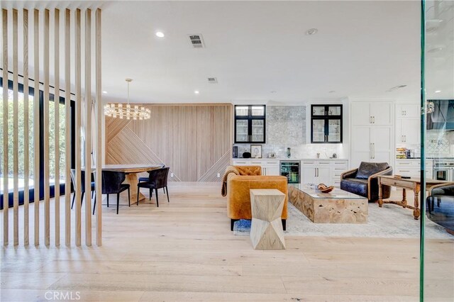 1852 6th St, Manhattan Beach, CA 90266 - living area featuring wine cooler, a chandelier, light wood-style floors, and recessed lighting