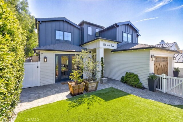 1852 6th St, Manhattan Beach, CA 90266 - back of house featuring a gate, board and batten siding, an attached garage, a patio area, and french doors