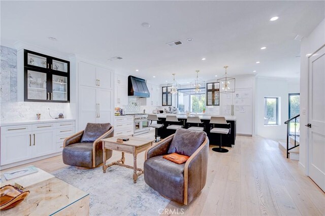 1852 6th St, Manhattan Beach, CA 90266 - living area with healthy amount of natural light, recessed lighting, light wood finished floors, and a chandelier