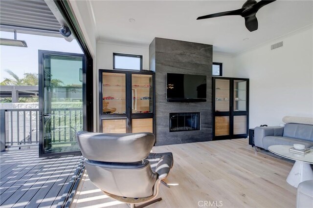1852 6th St, Manhattan Beach, CA 90266 - living room with a large fireplace, wood finished floors, crown molding, and a ceiling fan