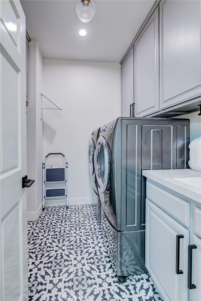 1852 6th St, Manhattan Beach, CA 90266 - washroom featuring cabinet space, washing machine and dryer, baseboards, and light floors