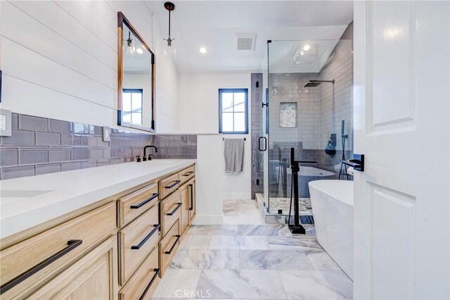 1852 6th St, Manhattan Beach, CA 90266 - full bathroom with a stall shower, double vanity, backsplash, marble look tile flooring, and a soaking tub