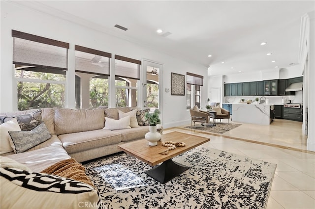 living room featuring recessed lighting, crown molding, and light tile patterned floors