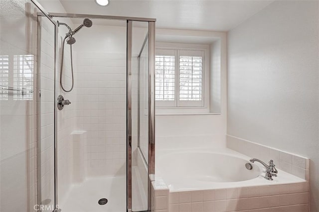 bathroom featuring a garden tub and a stall shower