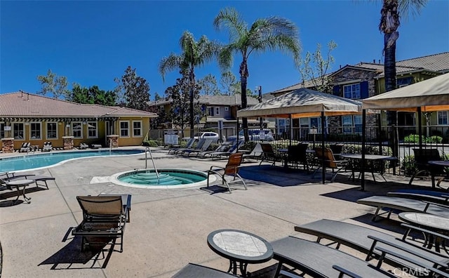 pool featuring fence, a community hot tub, a gazebo, and a patio