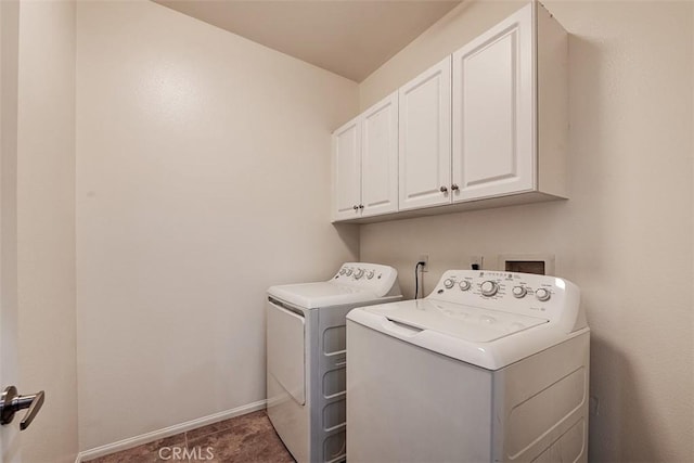 laundry area with cabinet space, baseboards, and washer and clothes dryer