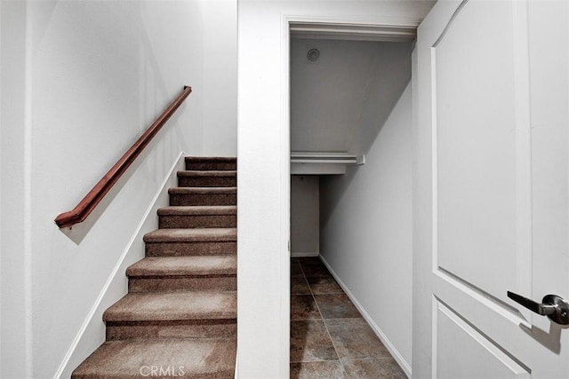 stairway featuring stone finish flooring and baseboards