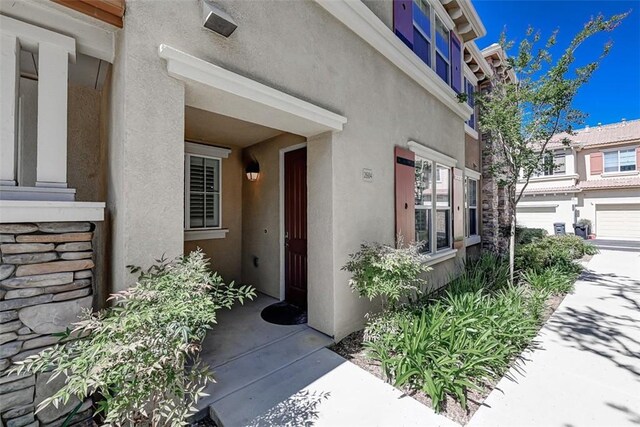 entrance to property with stucco siding