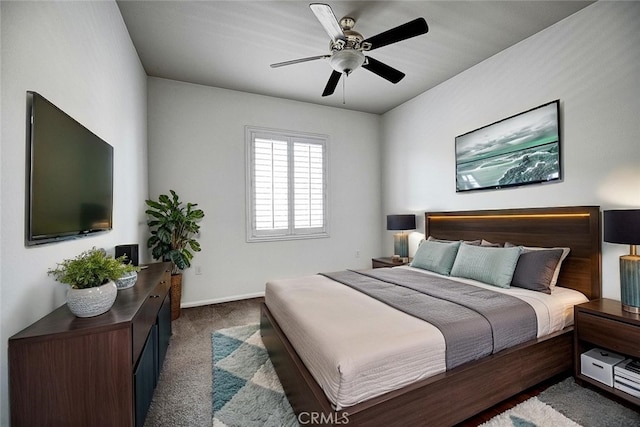 bedroom with a ceiling fan, baseboards, and carpet