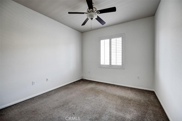 carpeted empty room featuring ceiling fan and baseboards