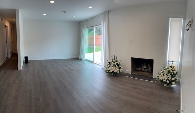 unfurnished living room featuring a fireplace, wood finished floors, recessed lighting, and baseboards