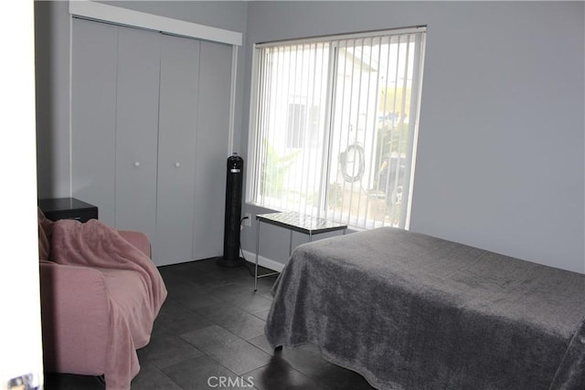 bedroom with a closet and baseboards