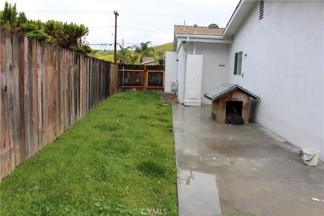 view of yard with a fenced backyard