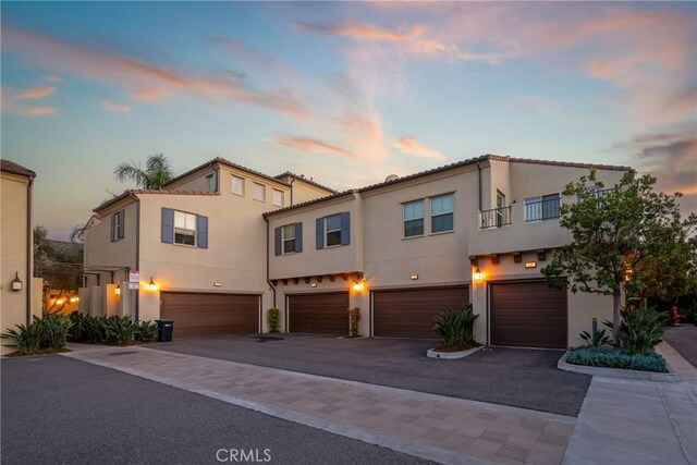 130 Borrego, Irvine, CA 92618 - multi unit property featuring an attached garage, stucco siding, and driveway
