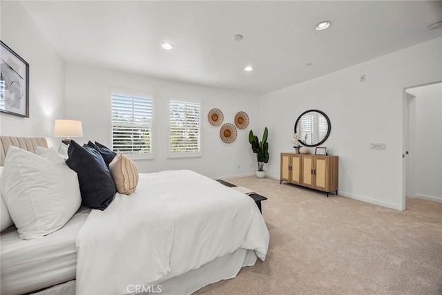 bedroom featuring light carpet, baseboards, and recessed lighting