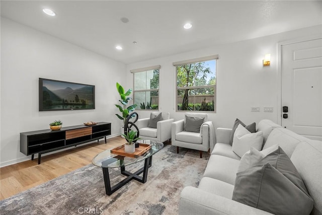 living room with recessed lighting, wood finished floors, and baseboards