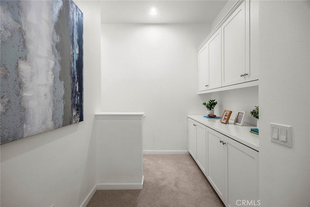 interior space featuring recessed lighting, baseboards, and light carpet