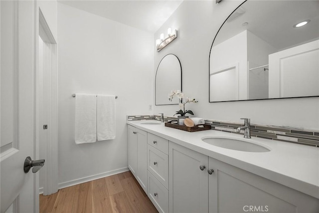 130 Borrego, Irvine, CA 92618 - bathroom featuring double vanity, wood finished floors, and recessed lighting