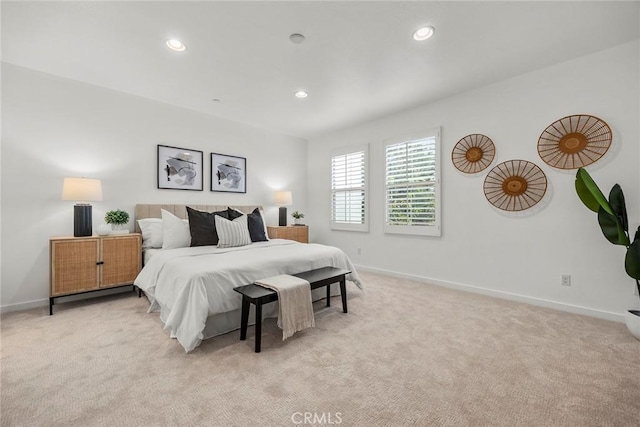 bedroom featuring recessed lighting, light colored carpet, and baseboards