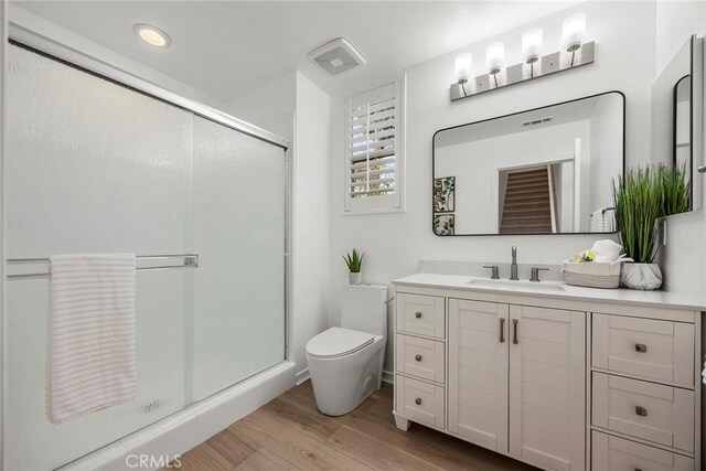 130 Borrego, Irvine, CA 92618 - bathroom featuring vanity, a shower stall, and wood finished floors
