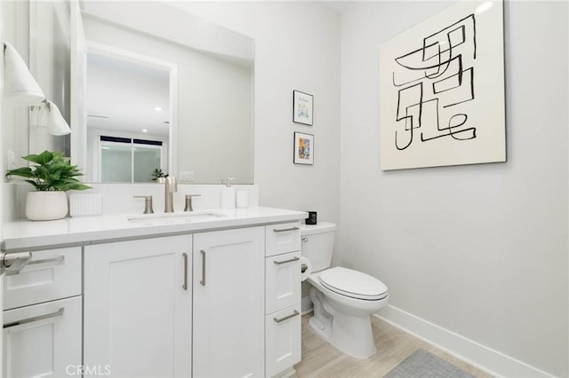 102 Pattern, Irvine, CA 92618 - bathroom featuring baseboards, wood finished floors, toilet, and vanity
