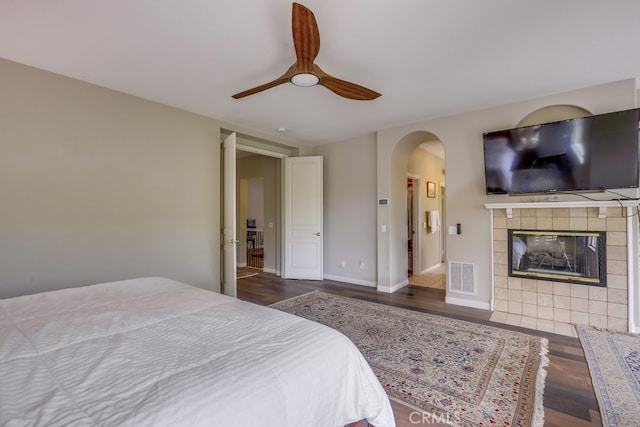 44 Water Lily Way, Coto De Caza, CA 92679 - bedroom featuring wood finished floors, visible vents, arched walkways, and a fireplace