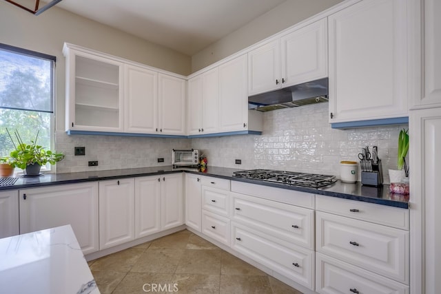 44 Water Lily Way, Coto De Caza, CA 92679 - kitchen featuring stainless steel gas stovetop, white cabinets, under cabinet range hood, decorative backsplash, and glass insert cabinets