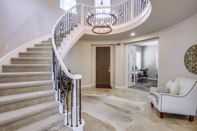 44 Water Lily Way, Coto De Caza, CA 92679 - tiled entrance foyer with visible vents, baseboards, a chandelier, a high ceiling, and stairs