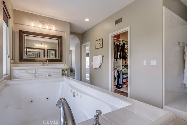44 Water Lily Way, Coto De Caza, CA 92679 - bathroom featuring recessed lighting, a spacious closet, visible vents, a tub with jets, and a sink