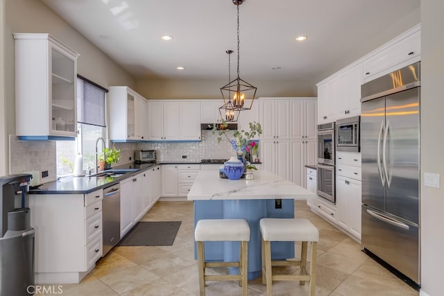 44 Water Lily Way, Coto De Caza, CA 92679 - kitchen with a sink, white cabinetry, decorative backsplash, built in appliances, and a kitchen island